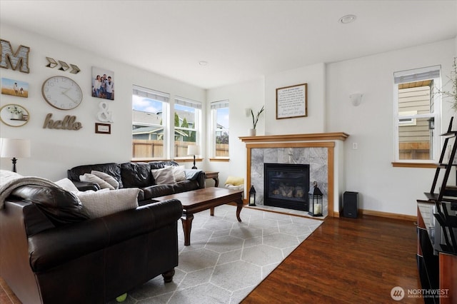 living area featuring recessed lighting, baseboards, wood finished floors, and a tile fireplace