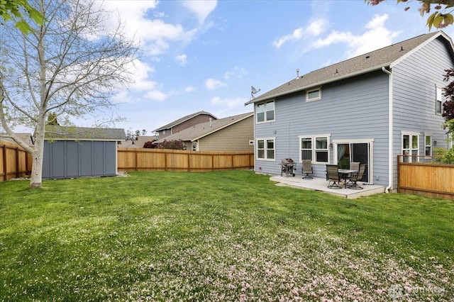 rear view of property with a lawn, a patio, and a fenced backyard