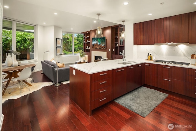 500 106th Ave NE Unit 611, Bellevue, WA 98004 - kitchen featuring a sink, modern cabinets, a peninsula, open floor plan, and dark wood-style flooring