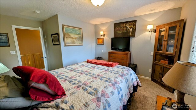 bedroom with carpet flooring and a textured ceiling