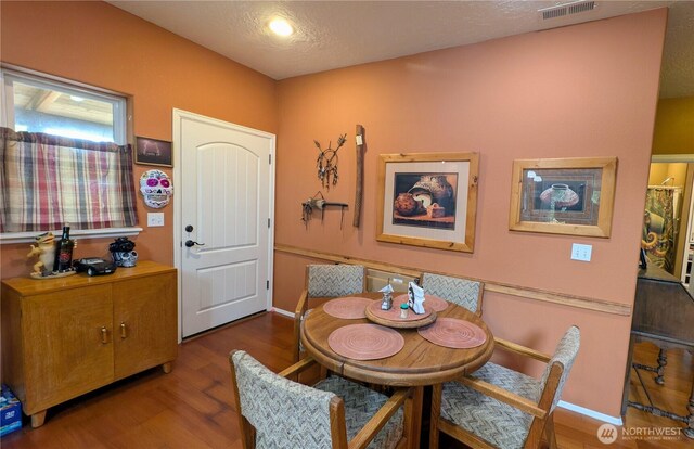 dining room with baseboards, wood finished floors, and visible vents