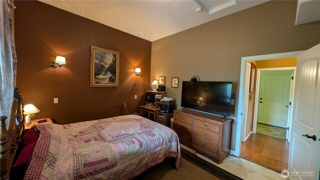 bedroom with baseboards and vaulted ceiling