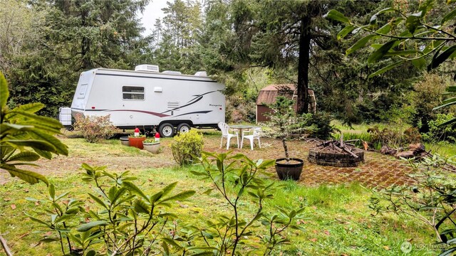 view of yard with an outdoor fire pit