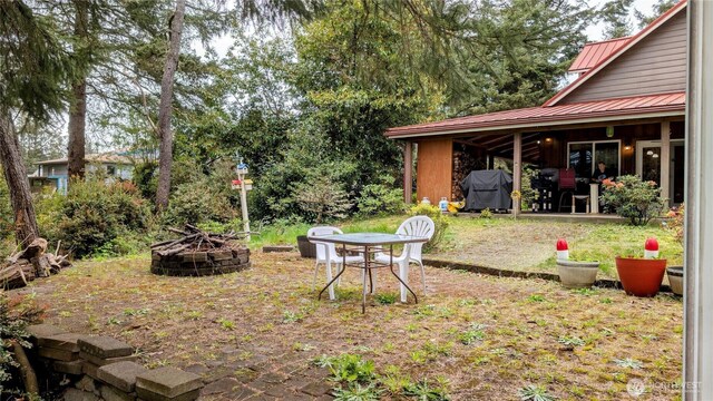 view of yard with a patio and an outdoor fire pit