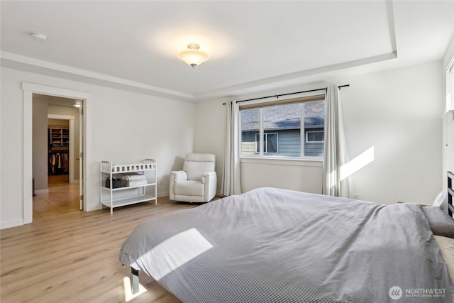 13218 106th Pl NE, Kirkland, WA 98034 - bedroom featuring baseboards, a raised ceiling, and light wood finished floors