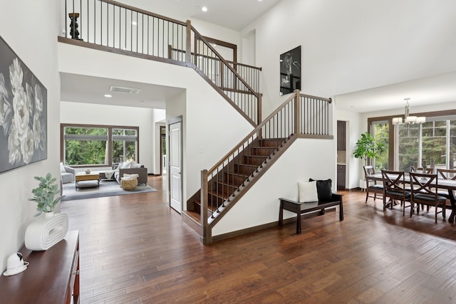 14835 NE 11th Pl, Bellevue, WA 98007 - staircase with a towering ceiling, wood-type flooring, a chandelier, and recessed lighting