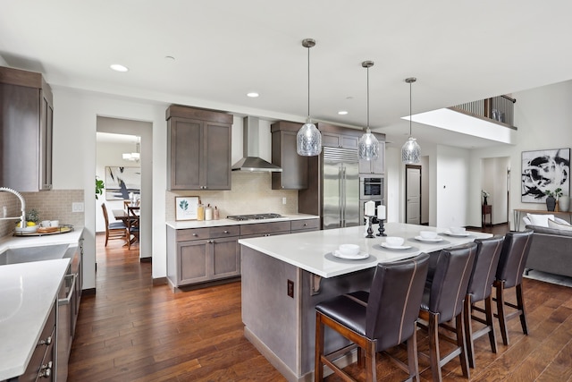 14835 NE 11th Pl, Bellevue, WA 98007 - kitchen with wall chimney range hood, appliances with stainless steel finishes, a sink, dark wood-style floors, and backsplash