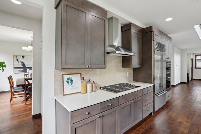 14835 NE 11th Pl, Bellevue, WA 98007 - kitchen featuring appliances with stainless steel finishes, wall chimney range hood, backsplash, dark wood-style floors, and light countertops