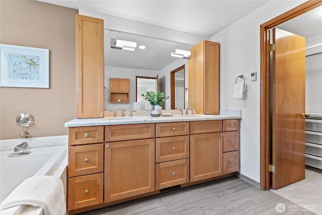 full bathroom featuring double vanity and a bath