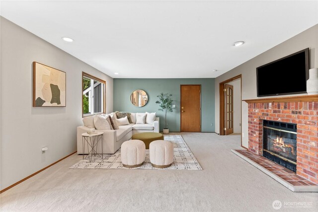 carpeted living area with a fireplace, baseboards, and recessed lighting