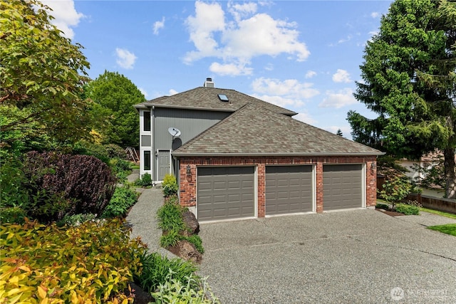 view of front of property featuring brick siding, roof with shingles, a garage, and driveway