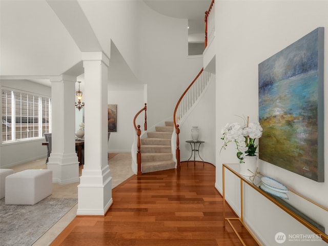 1206 S 36th Pl, Renton, WA 98055 - foyer with decorative columns, wood finished floors, stairway, and baseboards