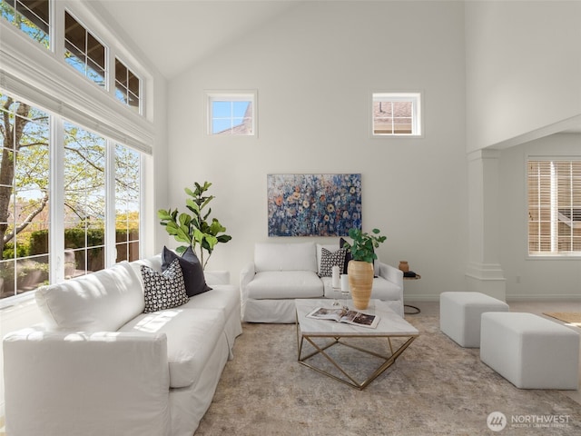 1206 S 36th Pl, Renton, WA 98055 - carpeted living area featuring high vaulted ceiling and baseboards