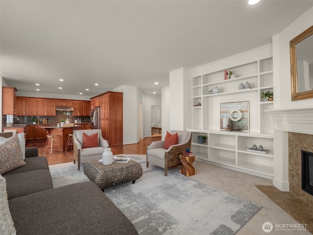 1206 S 36th Pl, Renton, WA 98055 - living area with a high end fireplace, recessed lighting, and built in shelves