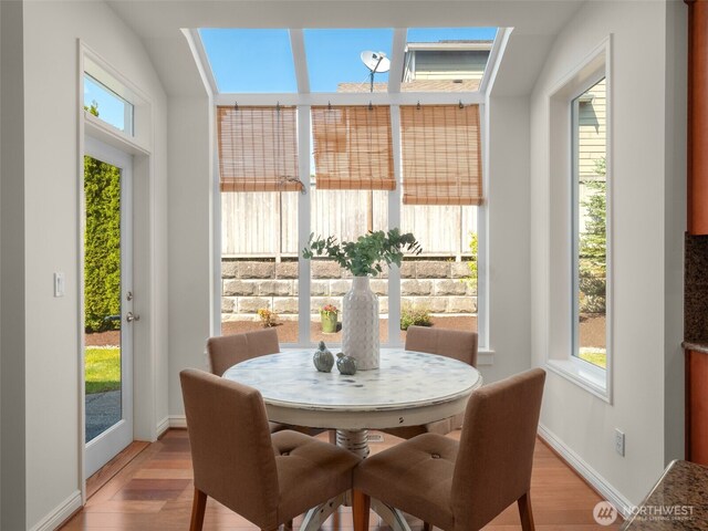 1206 S 36th Pl, Renton, WA 98055 - dining room with a skylight, light wood-style flooring, and baseboards