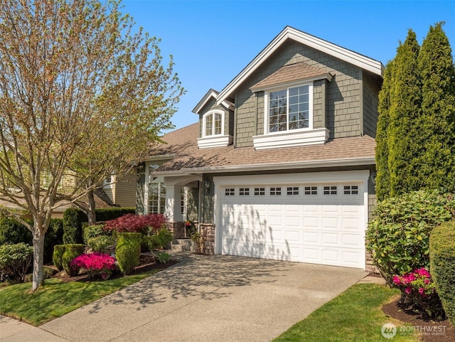1206 S 36th Pl, Renton, WA 98055 - view of front facade with an attached garage, driveway, a shingled roof, and stone siding