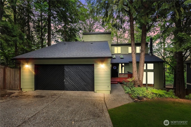 21827 4th Ave SE, Bothell, WA 98021 - view of front of home featuring driveway, a garage, roof with shingles, fence, and a wooden deck