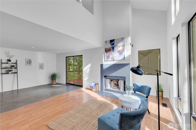 21827 4th Ave SE, Bothell, WA 98021 - living room with a tile fireplace, wood finished floors, and a towering ceiling