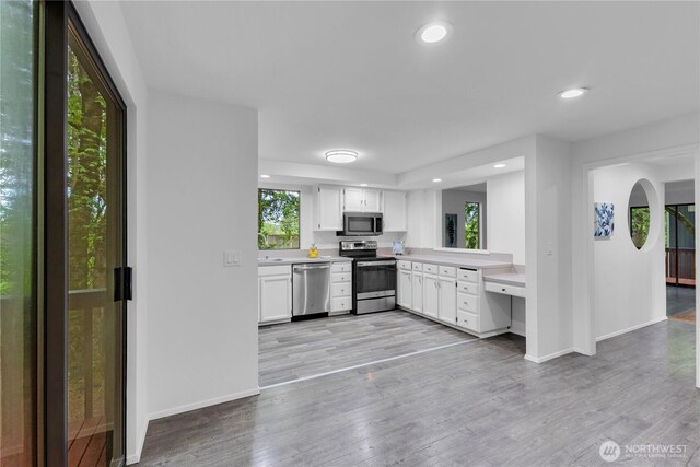 21827 4th Ave SE, Bothell, WA 98021 - kitchen with appliances with stainless steel finishes, light countertops, white cabinets, baseboards, and recessed lighting