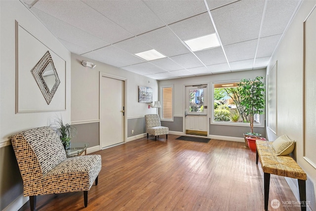 6910 California Ave SW Unit 26, Seattle, WA 98136 - living area featuring baseboards, a drop ceiling, and wood finished floors