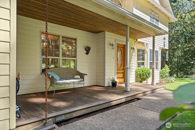 wooden deck featuring a porch and visible vents