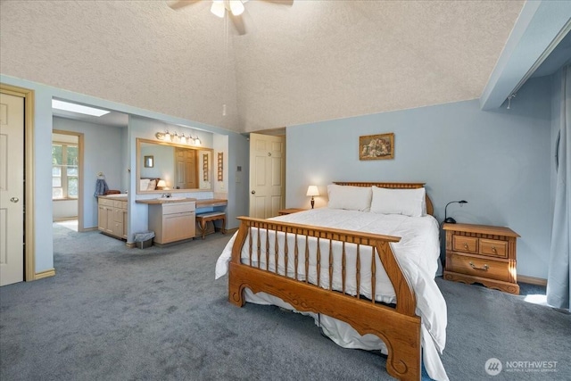 bedroom featuring a textured ceiling, light colored carpet, ceiling fan, and vaulted ceiling
