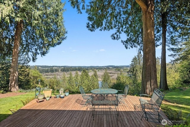 wooden deck with a yard and outdoor dining space