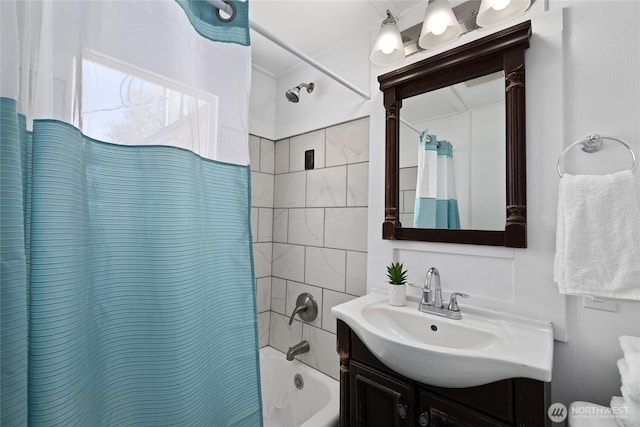 bathroom featuring vanity and shower / bathtub combination with curtain