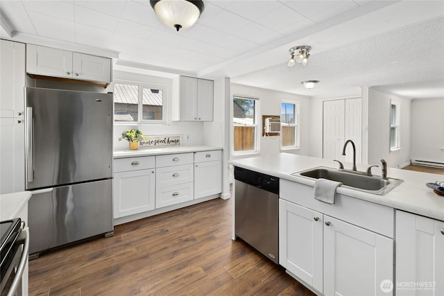 kitchen featuring plenty of natural light, a sink, light countertops, and stainless steel appliances