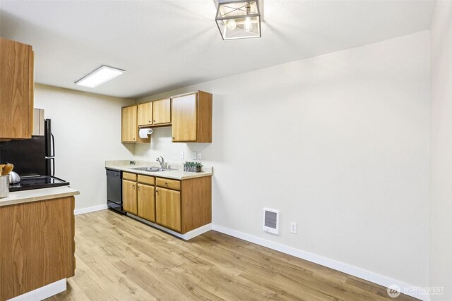 16817 Larch Way Unit B202, Lynnwood, WA 98037 - kitchen with visible vents, baseboards, light wood-type flooring, a sink, and black appliances