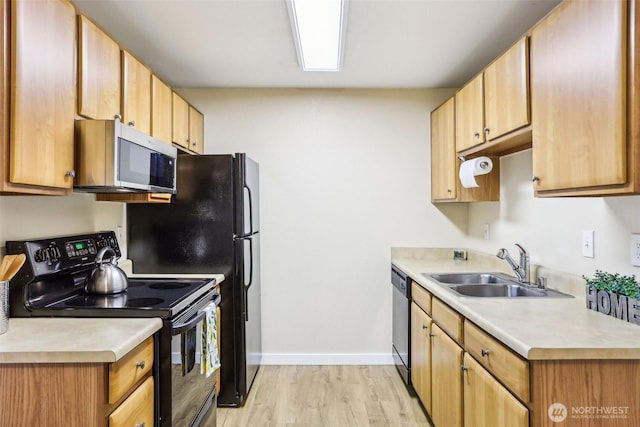 16817 Larch Way Unit B202, Lynnwood, WA 98037 - kitchen with a sink, baseboards, light countertops, stainless steel appliances, and light wood-style flooring
