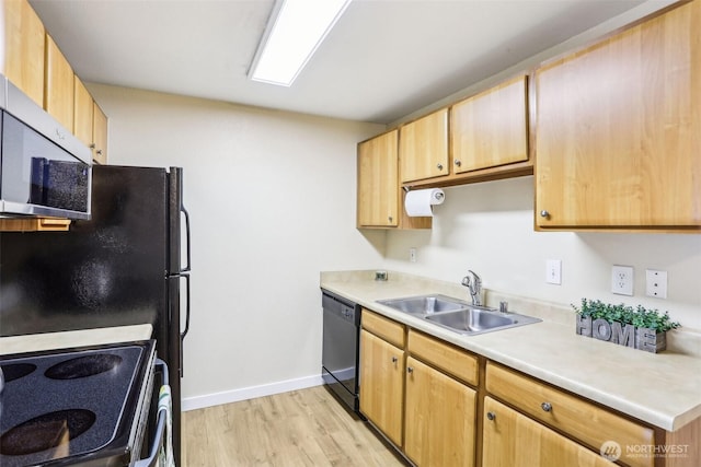 16817 Larch Way Unit B202, Lynnwood, WA 98037 - kitchen with a sink, light countertops, baseboards, light wood-type flooring, and black appliances