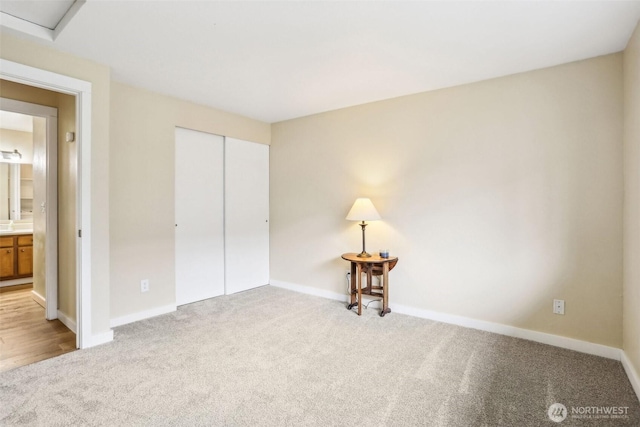 16817 Larch Way Unit B202, Lynnwood, WA 98037 - unfurnished bedroom featuring carpet floors, baseboards, and a closet