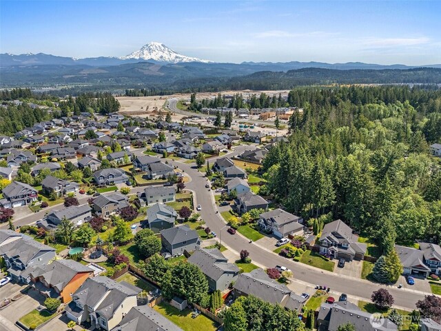 13211 174th St E, Puyallup, WA 98374 - aerial overview of property's location featuring a mountain backdrop and nearby suburban area