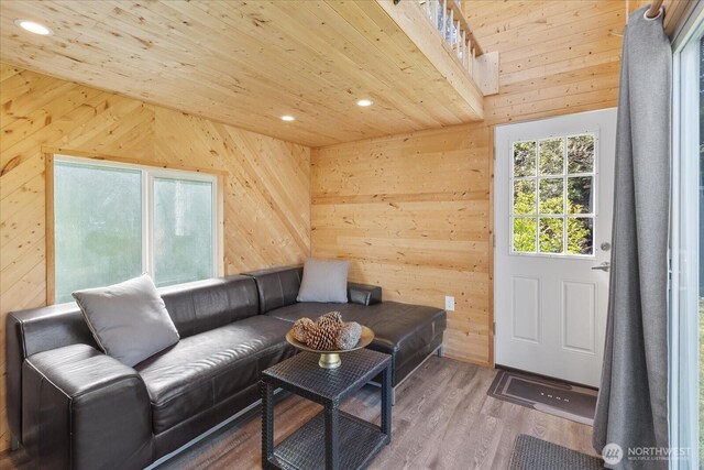 living area featuring wood walls, recessed lighting, wood ceiling, and wood finished floors