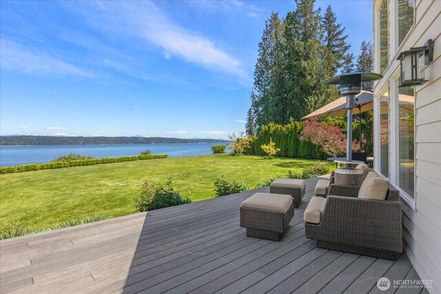 wooden deck featuring a water view and a yard