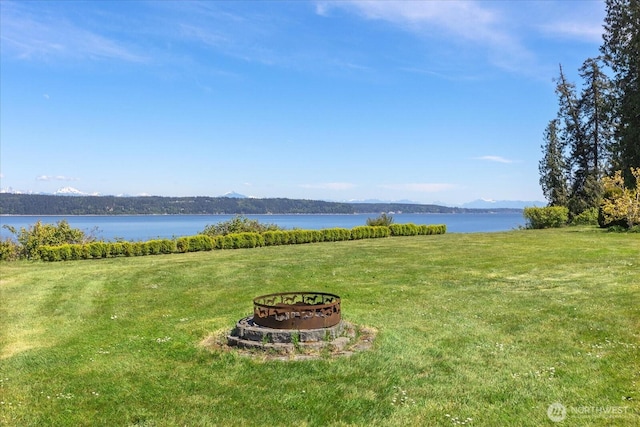water view featuring a fire pit and a mountainous background
