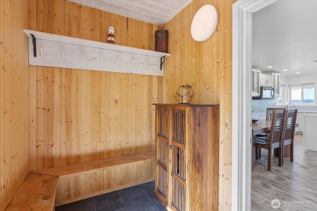mudroom with wooden walls
