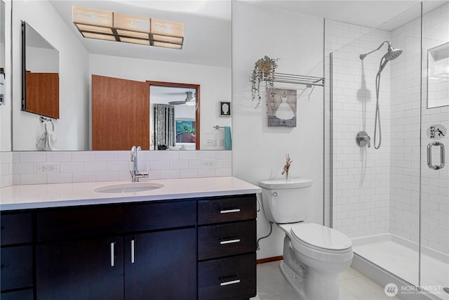 604 128th Ave SE, Bellevue, WA 98005 - full bathroom featuring tasteful backsplash, tile patterned floors, toilet, vanity, and a stall shower