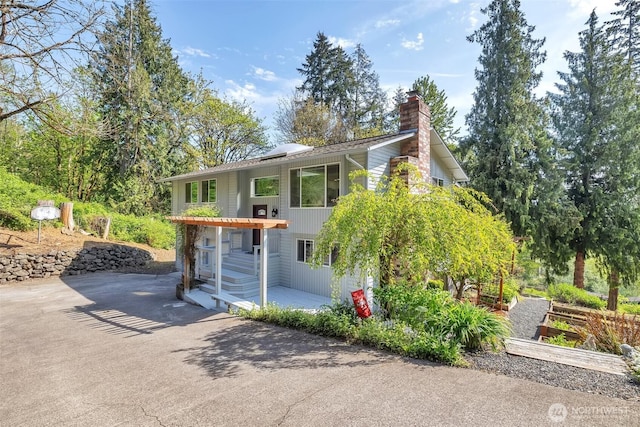 exterior space featuring a chimney and a patio area