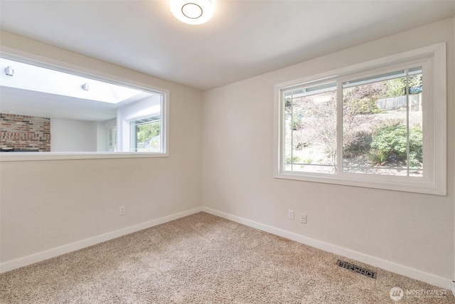 empty room featuring baseboards, carpet flooring, and visible vents
