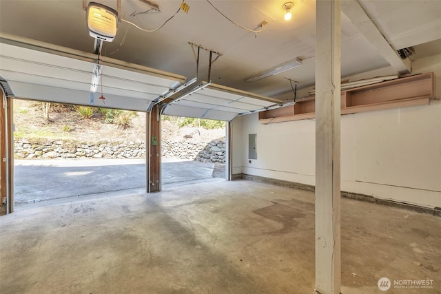 garage with a garage door opener and electric panel