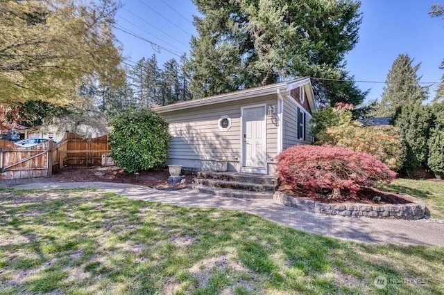 view of outbuilding featuring fence