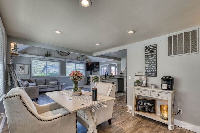 dining space featuring visible vents, baseboards, recessed lighting, vaulted ceiling, and wood finished floors