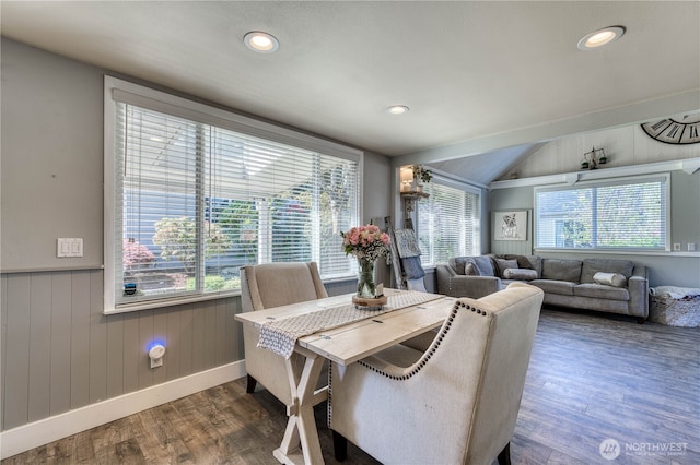 dining space with recessed lighting, wood finished floors, a wainscoted wall, wooden walls, and lofted ceiling