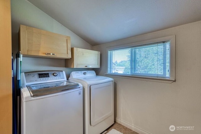 clothes washing area with baseboards, cabinet space, and independent washer and dryer