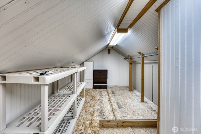 additional living space featuring lofted ceiling