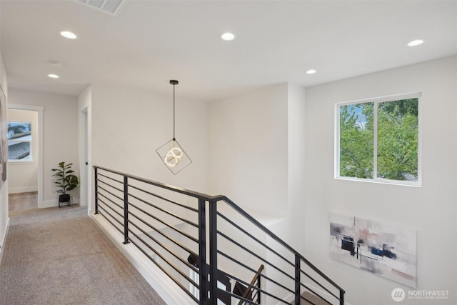 hall with recessed lighting, an upstairs landing, carpet, and visible vents