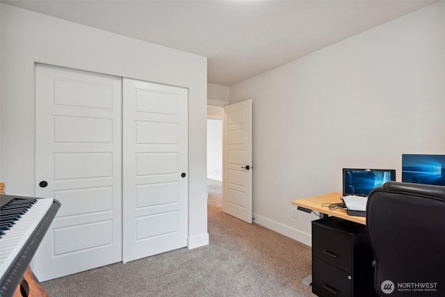 carpeted office space with baseboards
