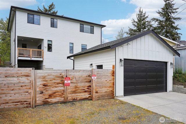 view of home's exterior with fence, an outdoor structure, and board and batten siding